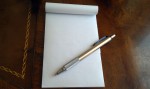 Writing pad of paper and pen